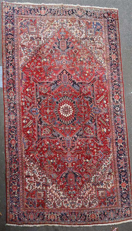 A Heriz red ground rug, 15ft 4in by 11ft 5in.